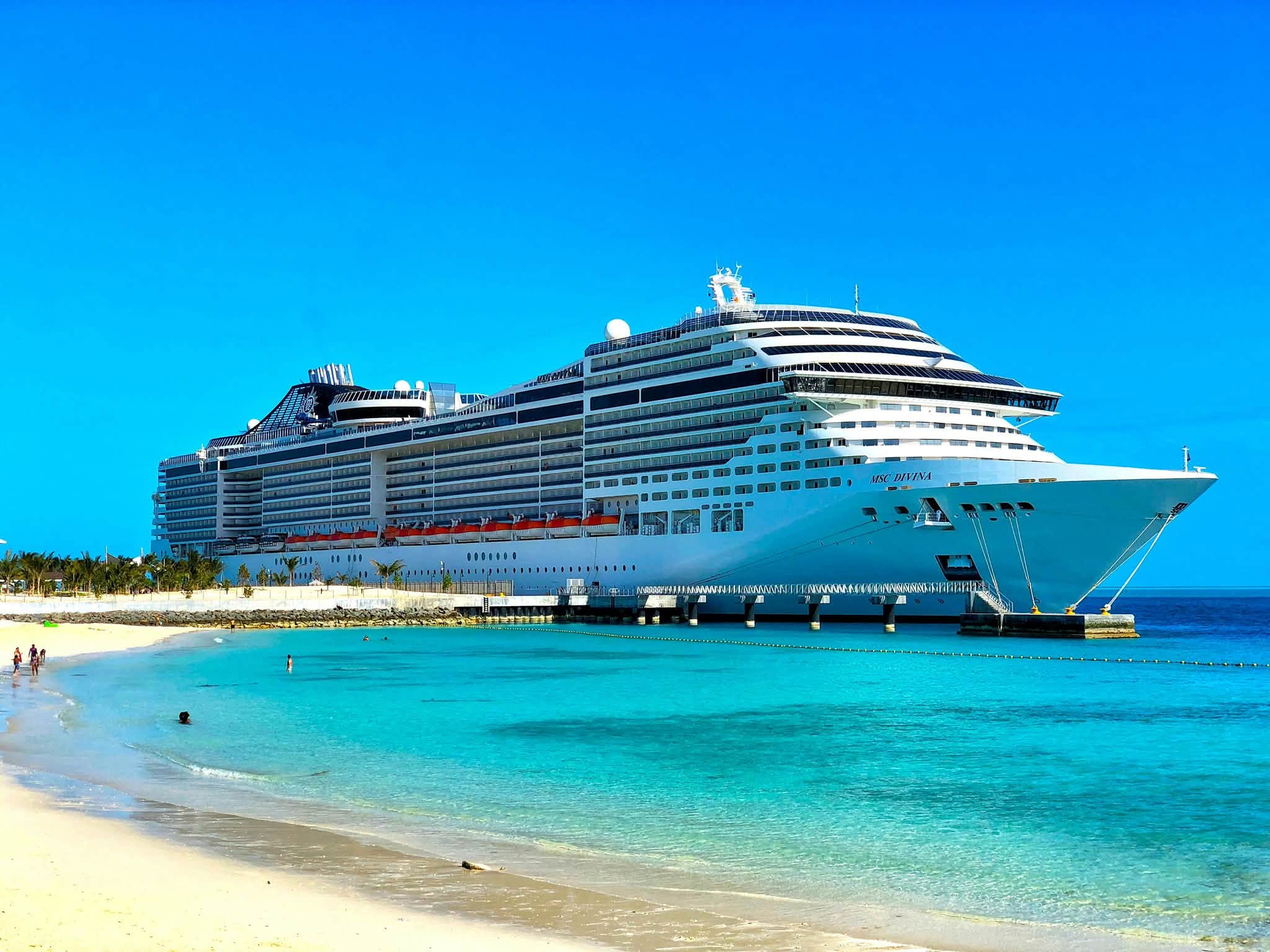 MSC Divina docked beside a tropical beach; ship photograph, not a port on this Mediterranean itinerary